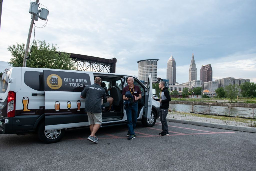 Tour guests exit the City Brew Tour van