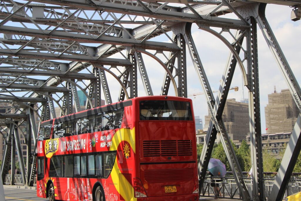 Double-decker sightseeing bus crossing a bridge, offering a fun and unique way to explore the city during a bachelorette party.