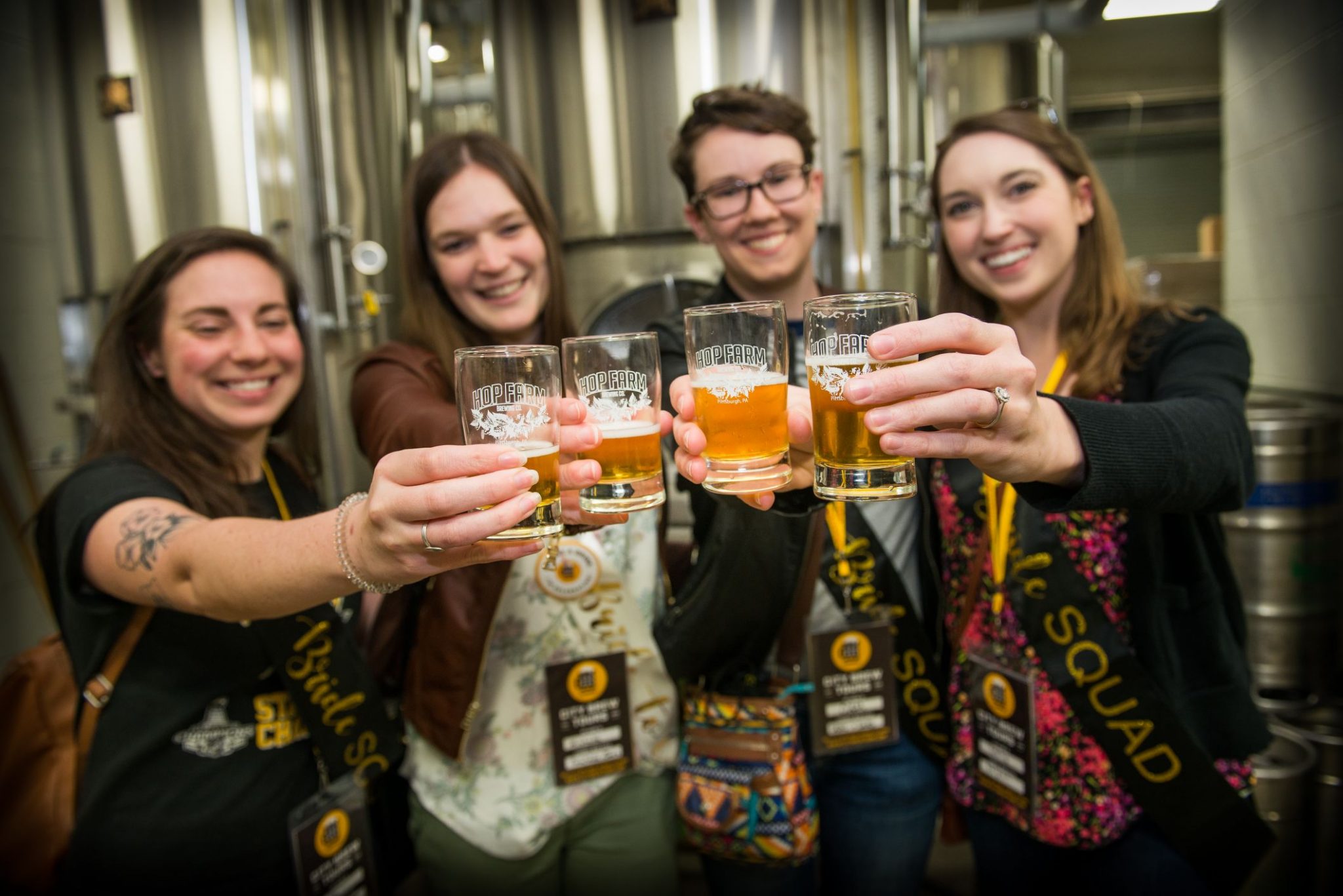 A bachelorette party cheers with Hop Farm branded beer glasses.