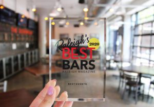 Clouds displaying their award for Raleigh's best bar 2020