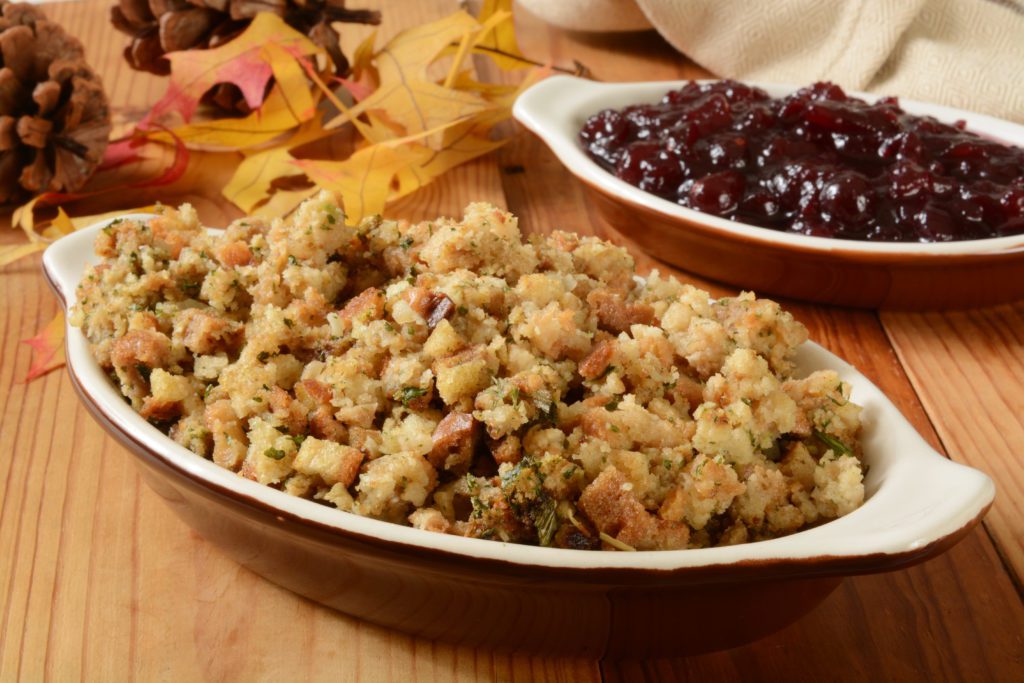 Turkey stuffing and cranberry sauce on a holiday table.