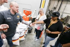 A City Brew Tours beer guide offers tour guests malted grain.