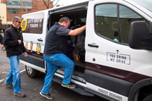 Two men approach the City Brew Tours van. Safety is our number one priority!